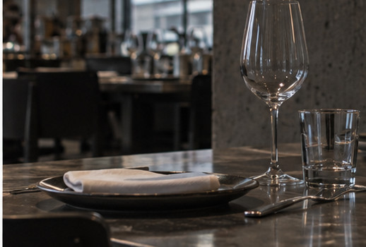 Une assiette, un verre de vin et un verre d'eau sur le comptoir en pierre